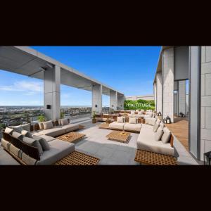 a view of a building with couches and chairs at 31 Sudirman Suites in Makassar