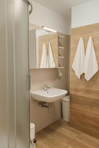 a bathroom with a sink and a mirror at Residence Antares in Riccione +12 photos