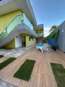a building with a staircase and a bench on a deck at WT Corais Flats in Maragogi