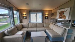 a living room with a couch and a table at East Lothian Escape in Port Seton