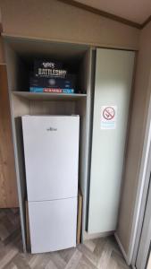 a refrigerator and a freezer in a cabinet at East Lothian Escape in Port Seton