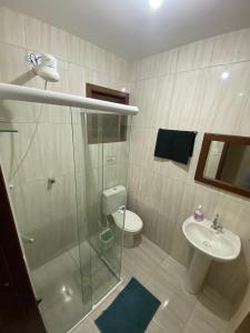 a bathroom with a shower and a sink and a toilet at Casa Azul Paraty in Paraty