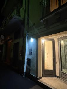 a door to a building with a light at night at IL moro in Acireale