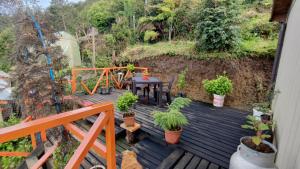 a wooden deck with a table and potted plants at Habitación con vista al mar in Puerto Montt