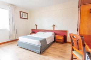 Ένα ή περισσότερα κρεβάτια σε δωμάτιο στο GoldMen Business Hotel Blumenau