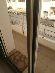 a sliding glass door with a view of a balcony at Studio Charmant & Cosy à Agdal in Gare de Rabat-Aguedal