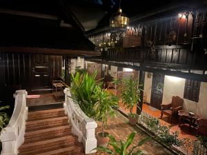 a porch of a house with a bunch of plants at Villa Phathana Boutique Hotel in Luang Prabang +62 photos