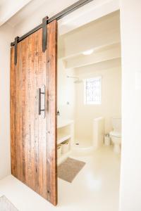 a sliding barn door in a bathroom with a toilet at Klein Paradys in Kleinmond