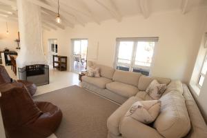 a living room with a couch and a fireplace at Klein Paradys in Kleinmond