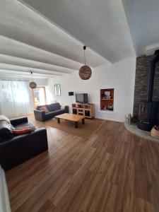 a living room with a couch and a table at Maison en pierre avec piscine in Ribes