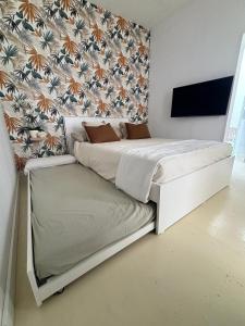 Ένα ή περισσότερα κρεβάτια σε δωμάτιο στο Los Hoteles