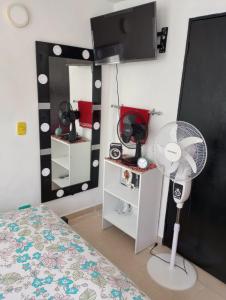 圣玛尔塔Deluxury的客房设有床、风扇和镜子