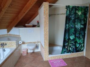 a bathroom with a tub and a toilet and a shower curtain at Casa Luna in Herdwangen-Schönach +10 photos