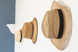 a pair of hats hanging on a wall at Relais Regina Giovanna in Sorrento