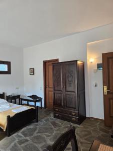 a bedroom with a bed and a cabinet and a table at Amalthia hotel in Límni
