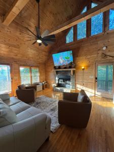 a living room with a couch and a tv at The Summit on Sunrise - Blue Ridge in Blue Ridge
