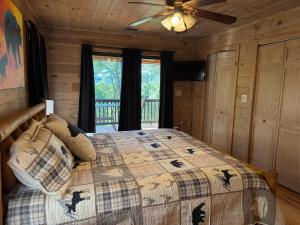 a bedroom with a bed in a log cabin at The Summit on Sunrise - Blue Ridge in Blue Ridge