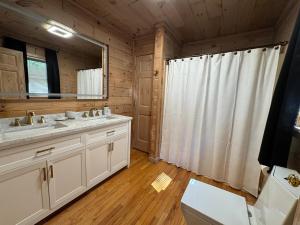 a bathroom with two sinks and a mirror at The Summit on Sunrise - Blue Ridge in Blue Ridge +43 photos