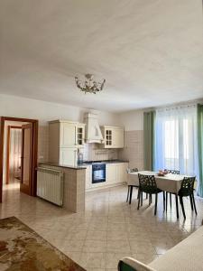 a kitchen and dining room with a table and chairs at Serravalle Shop&Stay in Serravalle Scrivia
