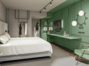 a bedroom with a white bed and green walls at ibis Styles Graz Messe in Graz +61 photos