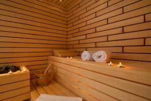 a sauna with candles and towels on a ledge at Villa ELLA ESTELLE with a heated pool, hot tub, sauna in Mimice