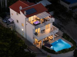 an aerial view of a house with a swimming pool at Villa ELLA ESTELLE with a heated pool, hot tub, sauna in Mimice