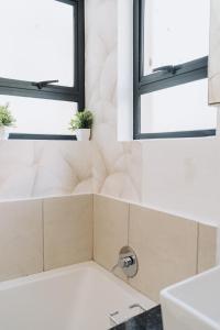 a bathroom with a sink and a window at Ihita unit 11 in Sandton