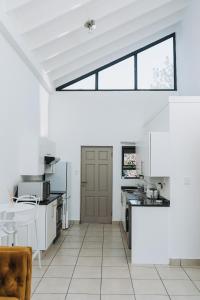 a kitchen with white appliances and a large window at Ihita unit 11 in Sandton
