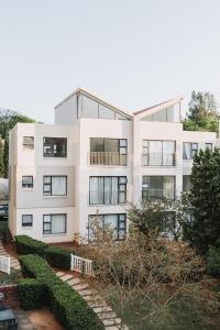 an apartment building with a garden in front of it at Ihita unit 11 in Sandton +52 photos