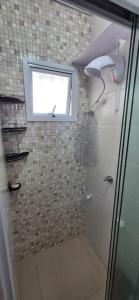 a bathroom with a shower with a window at MM Apart Premium Joinville in Joinville +20 photos