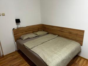 a bed with two pillows on it in a room at Mance apartments 2 in Paraćin