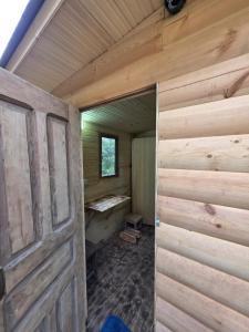 an inside view of a wooden cabin with a door at Nature House in Kutaisi