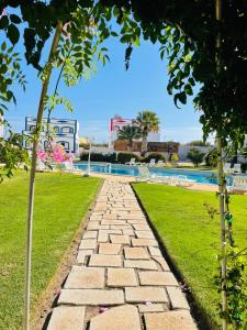 a stone pathway leading to a swimming pool at Casa Papillon in Sagres