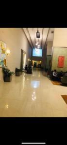 a large room with a lobby with people sitting in chairs at Lazy happ stay in Greater Noida