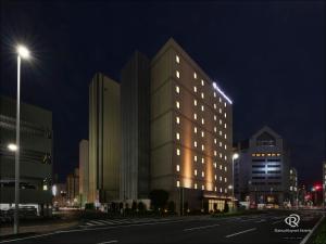 a lit up building on a city street at night at Daiwa Roynet Utsunomiya in Utsunomiya