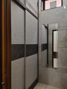 a bathroom with a glass shower door with a mirror at Pushp-Raj in Jodhpur +47 photos