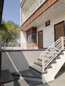 a house with a staircase leading to the front porch at Pushp-Raj in Jodhpur
