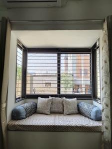 a window seat in front of a large window at Pushp-Raj in Jodhpur