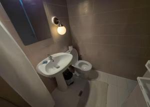 une salle de bain avec un lavabo et des toilettes dans l'établissement Κέντρο Καλαμάτας 4, à Kalamata