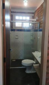 a bathroom with a shower with a toilet and a sink at Wind Villa Cumbuco - Casa in Cumbuco