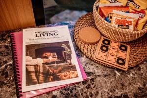 a book sitting on top of a table next to a basket at Hermano Farm Stay by Tiny Away in Greenhills