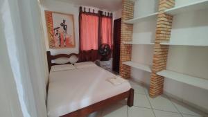 a small bedroom with a bed and a window at Loft Rústico com Piscina e Churrasqueira in Aquiraz +34 photos