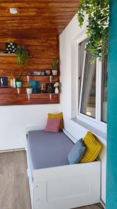 a white bench in a room with a window at Edelweiss Apartments in Villach