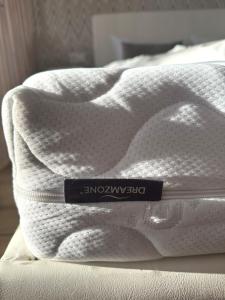 a white blanket on top of a bed at Feels like home in Visaginas