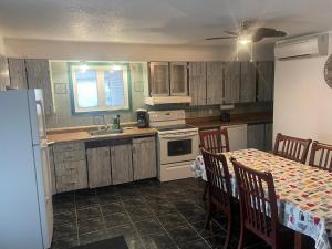 a kitchen with a table and a sink and a stove at Large Farm in Bélanger +5 photos