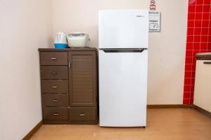 a white refrigerator in a kitchen next to a cabinet at Kushiro - House - Vacation STAY 20411 in Irifunechō +8 photos
