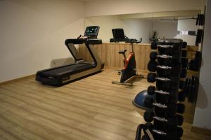 a room with a gym with a treadmill and a phone at Douro Marina Hotel & SPA in Resende