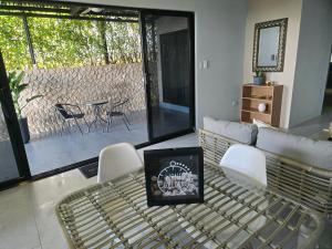 a living room with a couch and a table and chairs at Uvita, Ocean View in Uvita
