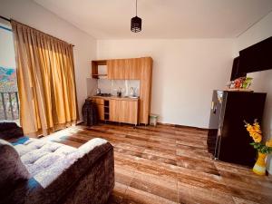 a living room with a couch and a kitchen at Hotel Alma Verde in Chiquinquirá