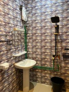 a bathroom with a sink and a phone on the wall at EZK Appart in Kika